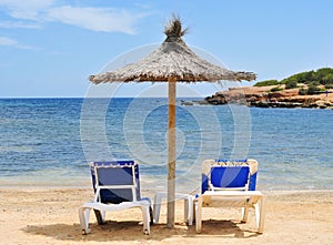 Umbrella and sunloungers in Ibiza, Spain