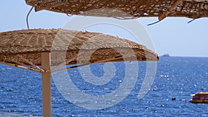 Umbrellas on the Background of the Sea on the Empty Beach in Egypt