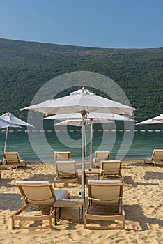 Umbrellas and beach loungers on golden beach
