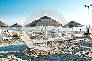 Umbrellas and chaise lounges on the beach of Rimini in Italy