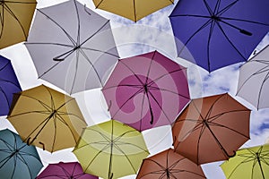 Umbrellas against a cloudy sky