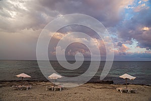 Umbrellas and hammocks on the empty beach photo