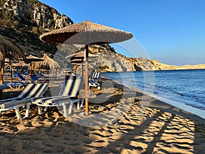 Umbrellas and lounges on the Tsambika beach