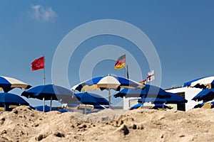 Umbrellas open on the beach against the blue summer sky