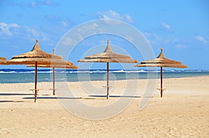 Umbrellas on sandy beach at hotel in Marsa Alam - Egypt photo