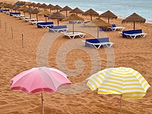 Umbrellas and sun chairs at an empty beach
