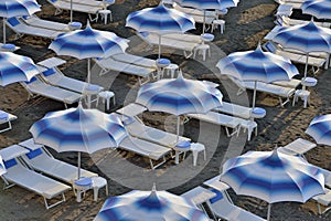 Umbrellas and sunloungers on empty beach