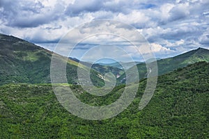 Umbrian Apennines with green wood and blue sky with clouds, Umbria, Italy