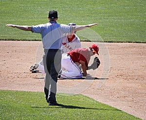 The umpire signals safe