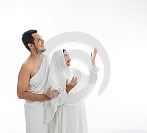 Umrah couple presenting copyspace