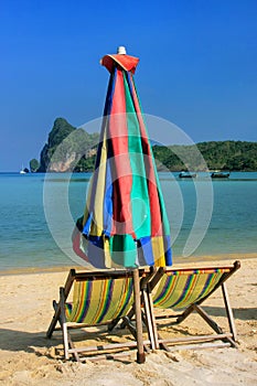 Umrella and sunchairs at Ao Loh Dalum beach on Phi Phi Don Island, Krabi Province, Thailand