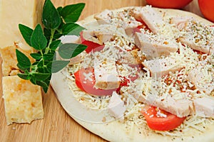 Un-cooked Chicken And Asiago Cheese Pizza