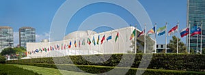 UN United Nations general assembly building with world flags fly