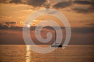 Un velero descansa durante la salida del sol en la costa de PeÃÂ±ÃÂ­scola photo