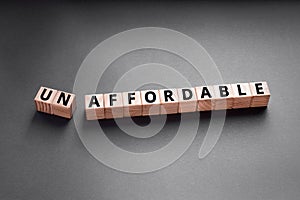 unaffordable to un affordable- words from wooden blocks with letters photo