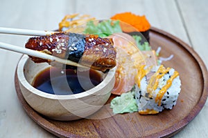 Unagi sushi nigiri in chopsticks