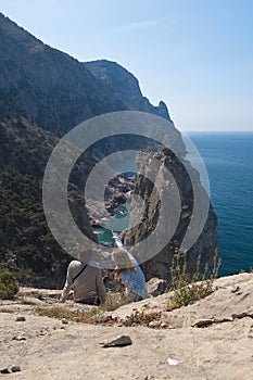 Unapproachable rock in the sea and tourists