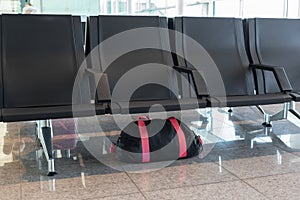 Unattended bag left under chair in the airport or bus or train station.