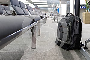 Unattended cabin backpack abandoned on the floor at airport.