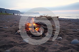 unattended campfire on a beach, smoke fading