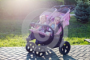 An unattended stroller with two children in a city