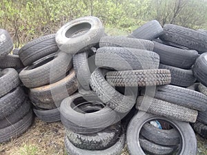 Unauthorized dumping of old car tires on the outskirts of the city