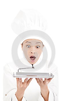 Unbelievable asian woman chef holding tray