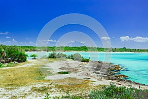amazing view from a cliff on tranquil turquoise ocean and beach against blue sky magic background at Cayo Coco Cuban island