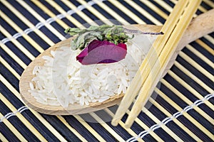 Unboiled rice on wooden spoon