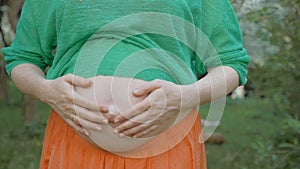 Unborn Baby Pushing the Belly of Pregnant Woman