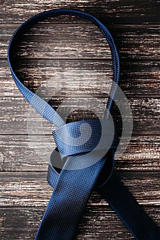 Unbound tie knot on dark background