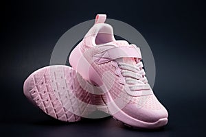 Unbranded pink running shoes on a black background