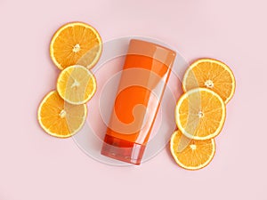 Unbranded red orange shampoo, shower gel or sunscreen cream bottle with vitamin c branding concept. Cosmetic skincare product
