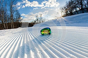 Unbroken ski slope and goggles