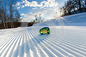 Unbroken ski slope and goggles photo