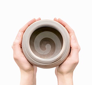 Unburnt clay pot in a woman's hands photo