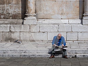 Uncaring old man reading