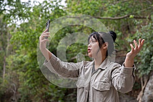 Uncertain Asian woman got lost and could not find an internet connection on her phone while hiking