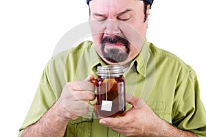Uncertain middle aged man with healthy cup of tea