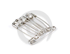 Unch of safety pins on white background, shiny metal safety pin photo