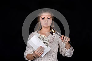 Unchained woman holding gavel and envelope with money