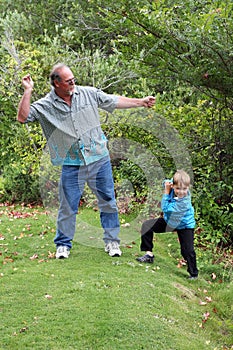 Uncle teaches boy to skip stones photo