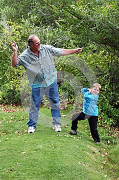 Uncle teaches nephew to skip stones photo