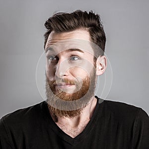 Unconfident and worried young man isolated on gray background photo