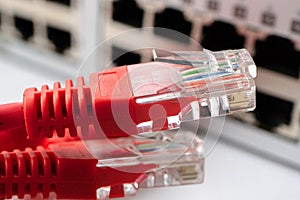 Unconnected red cables lying near the switch of the Internet provider