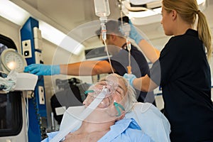 Unconscious patient with oxygen mask in ambulance