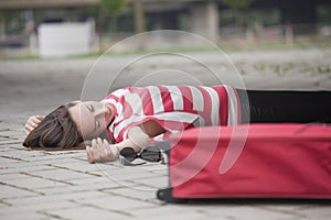 Unconscious woman on asphalt road