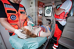 Unconscious woman and working paramedics photo