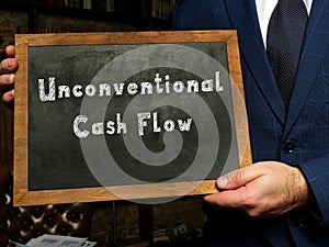 Unconventional Cash Flow inscription on the black chalkboard