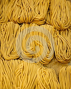 Uncoocked raw egg yellow noodles, top view, isolated in cubes